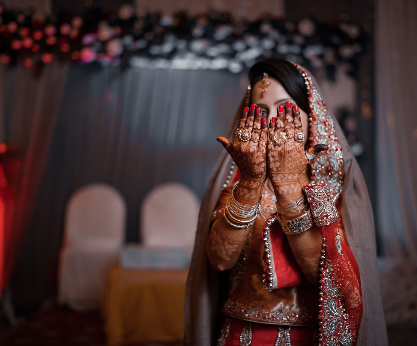 Bride showing detailed henna artwork on her hands