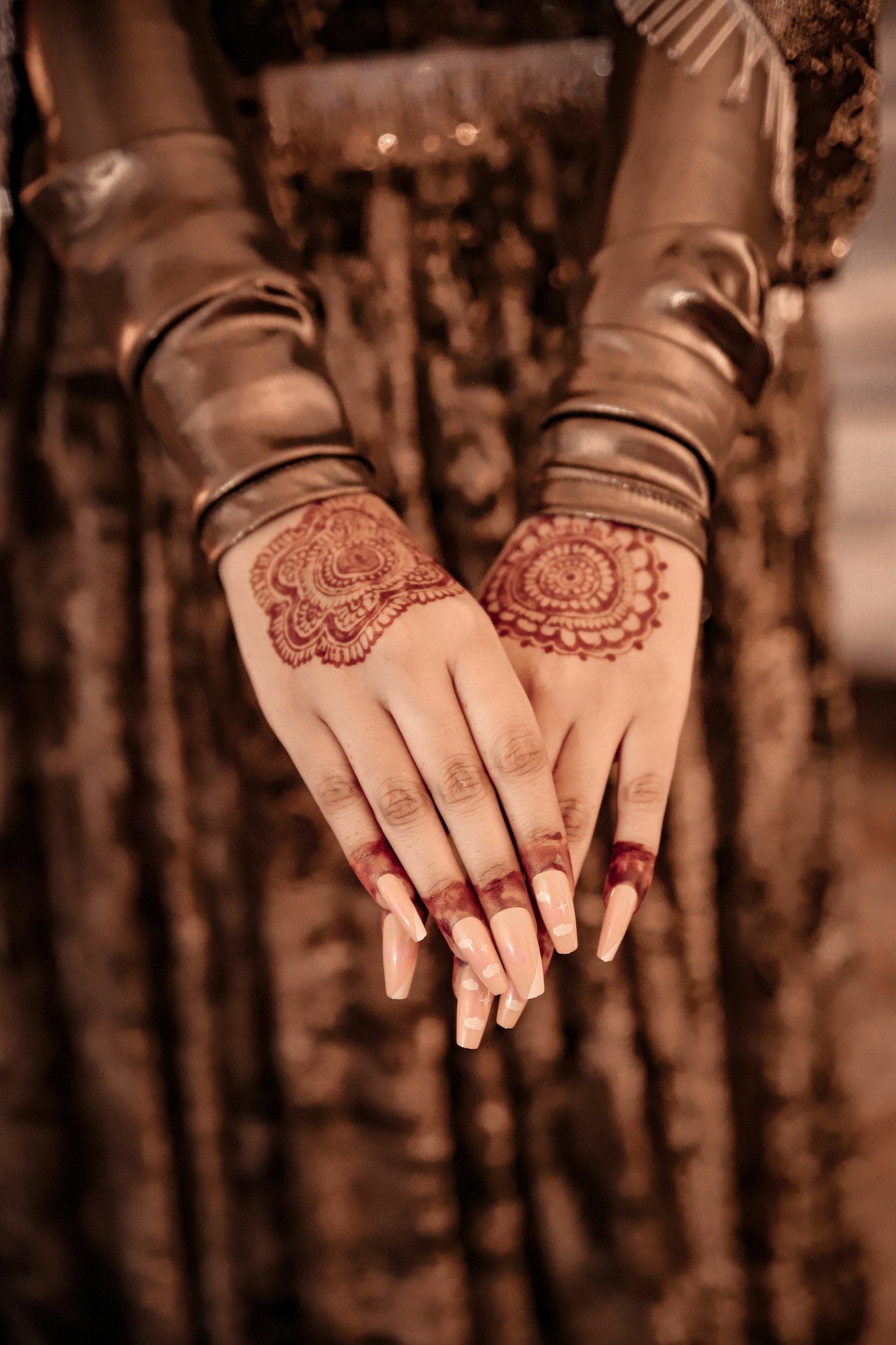 Woman displaying intricate mehndi on both hands